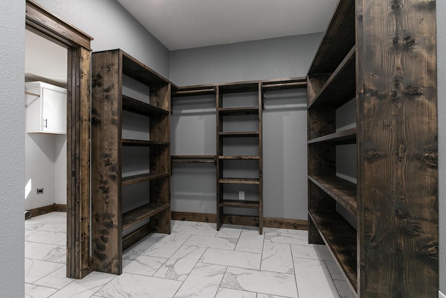 spacious closet with marble finish floor