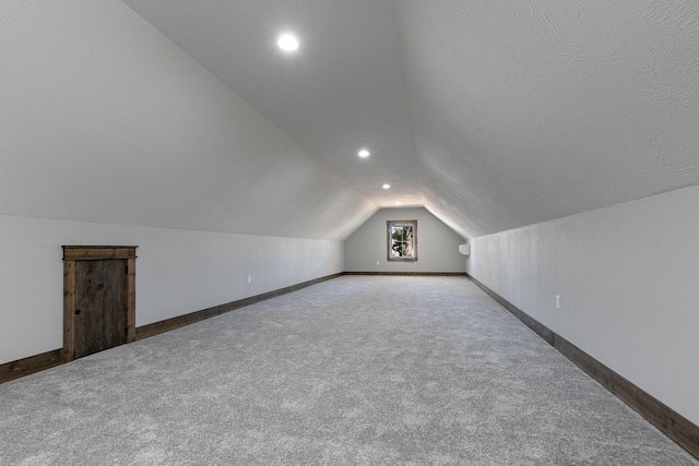 bonus room featuring lofted ceiling, recessed lighting, carpet flooring, and baseboards