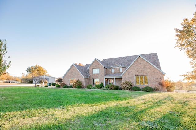 view of front of home featuring a front yard and brick siding