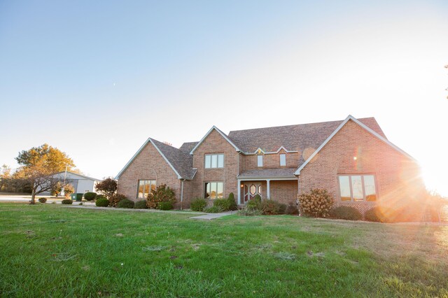 view of front of house with brick siding and a front yard