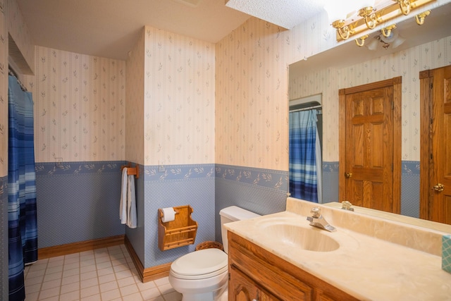 bathroom with curtained shower, wainscoting, toilet, and wallpapered walls