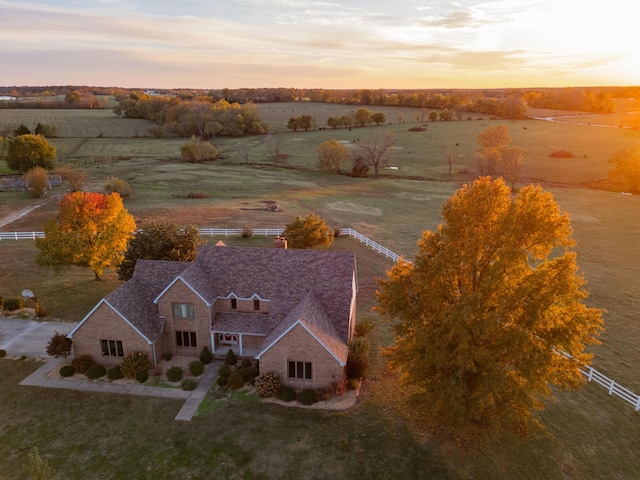 aerial view at dusk featuring a rural view