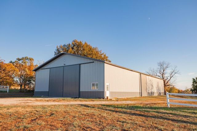 view of pole building featuring a yard and fence