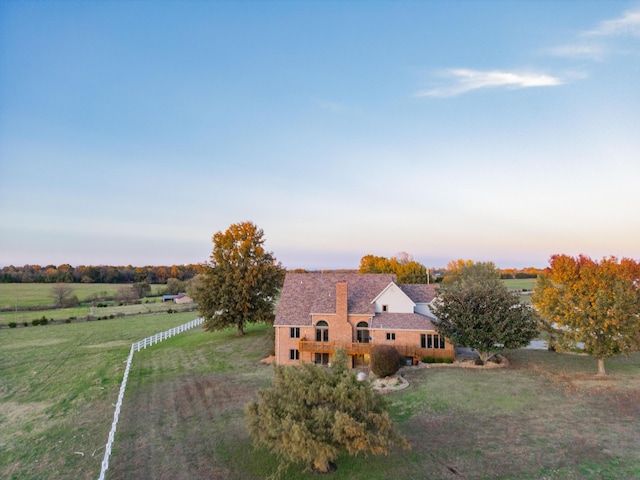 exterior space with a chimney and a rural view