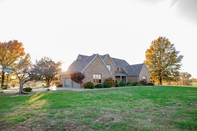 view of front of property featuring a front lawn and brick siding