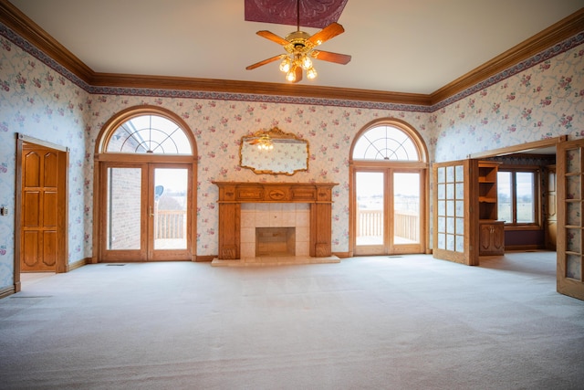 unfurnished living room featuring french doors, carpet, and wallpapered walls