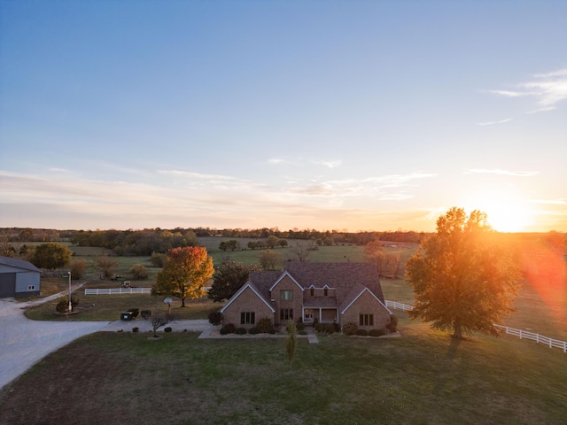 aerial view at dusk featuring a rural view