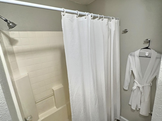 bathroom featuring shower / bathtub combination with curtain