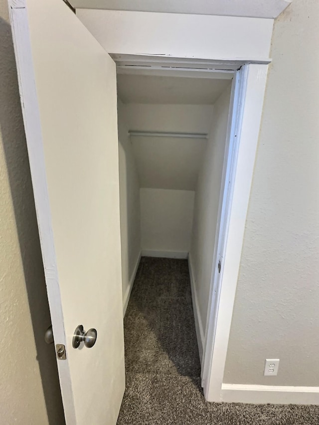 corridor featuring carpet flooring and baseboards