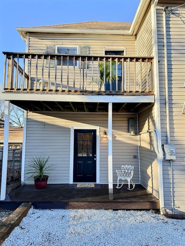 rear view of house with covered porch and a balcony