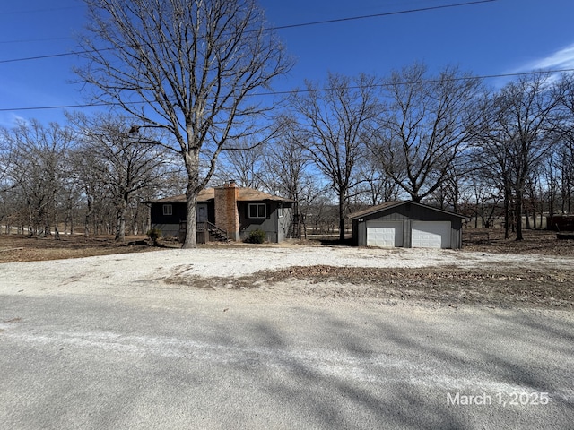 view of yard with a garage and an outbuilding