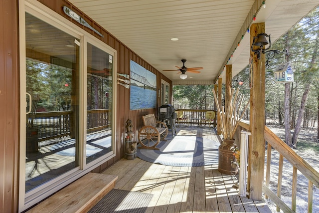 wooden deck with covered porch and ceiling fan