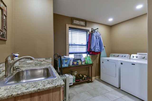 clothes washing area featuring laundry area, independent washer and dryer, a sink, and light tile patterned flooring