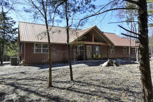 rear view of property featuring board and batten siding, a porch, metal roof, and central air condition unit