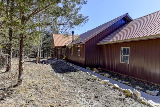 view of side of home featuring metal roof