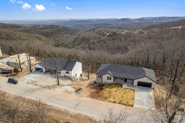 birds eye view of property featuring a forest view and a mountain view