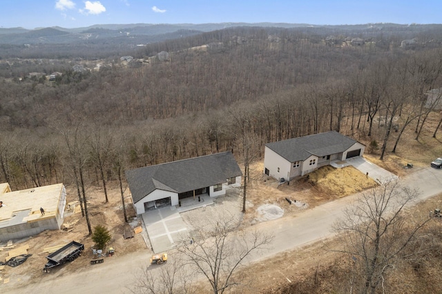 birds eye view of property with a forest view