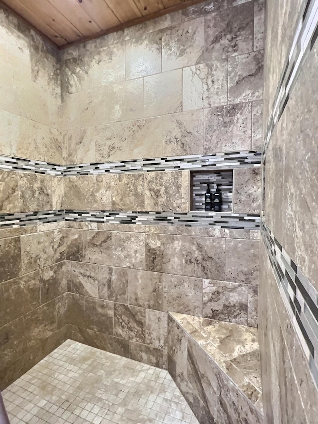 bathroom featuring tiled shower and wood ceiling