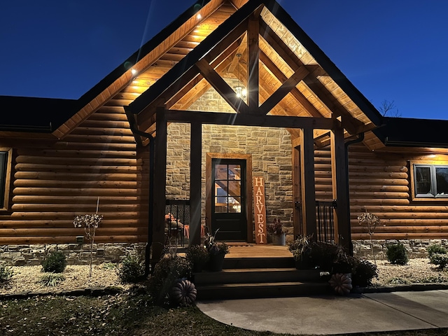 exterior entry at twilight with stone siding