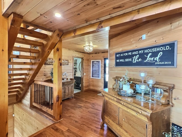 corridor with stairs, wood finished floors, wood ceiling, and wooden walls