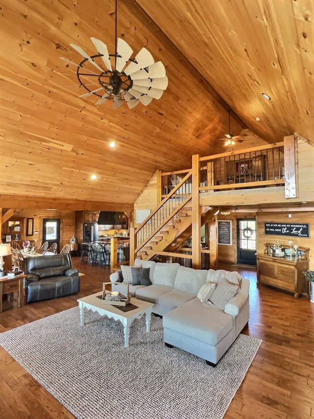 living area with high vaulted ceiling, stairway, wooden ceiling, and wood finished floors