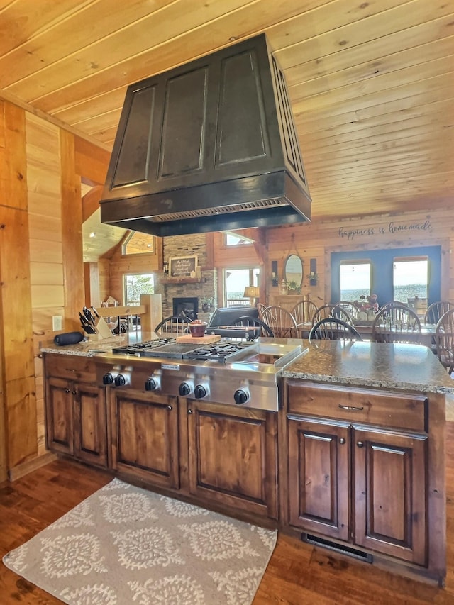 kitchen featuring wooden ceiling, wood walls, and premium range hood