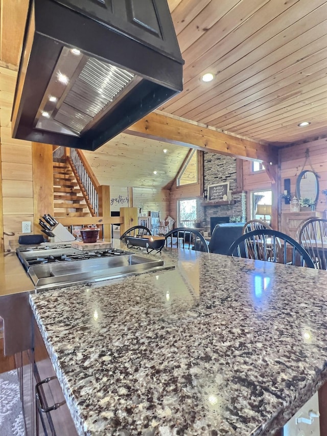 kitchen with wooden ceiling, wood walls, lofted ceiling with beams, and extractor fan