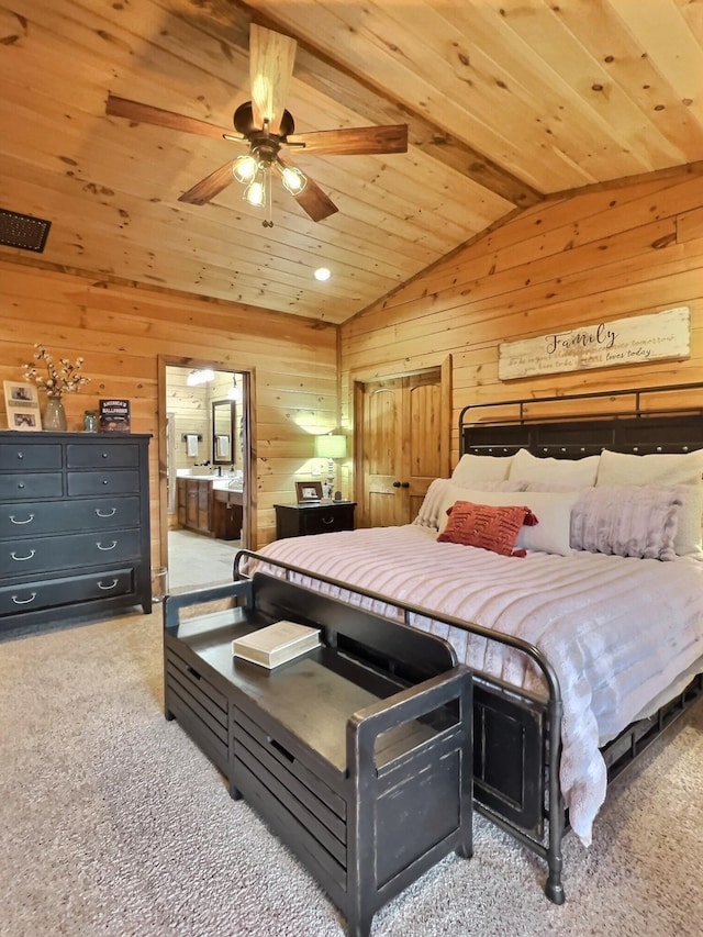 bedroom featuring wood ceiling, ensuite bathroom, vaulted ceiling, carpet flooring, and wood walls