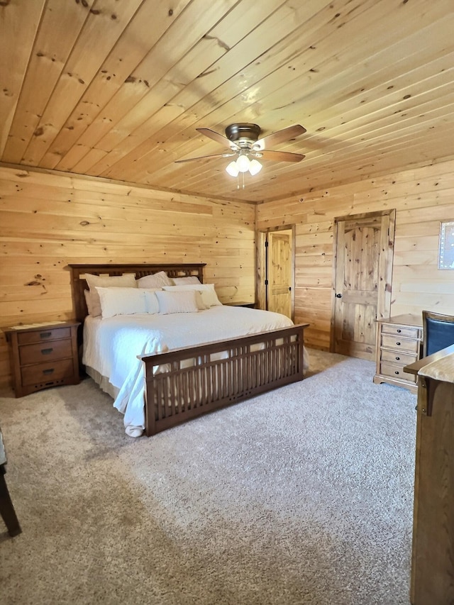 unfurnished bedroom featuring wood ceiling, wooden walls, and carpet flooring