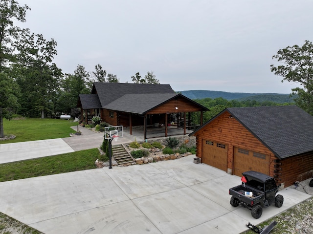 50 Parkview Ln, Van Buren, MO 63965 - view of front of house featuring a porch, a front lawn, a shingled roof, a garage, and log exterior