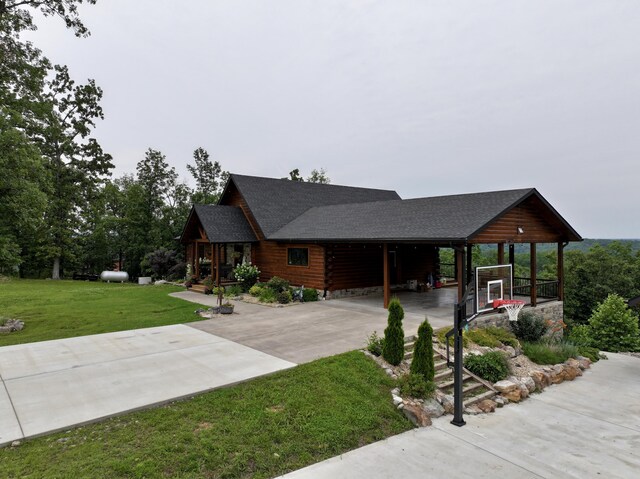 50 Parkview Ln, Van Buren, MO 63965 - log cabin with driveway, a front lawn, a shingled roof, and a carport