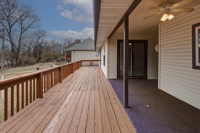 wooden terrace featuring a ceiling fan