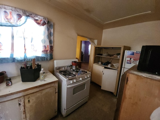 kitchen featuring white gas range oven and light countertops