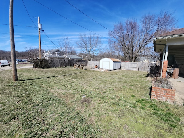 view of yard with a storage shed, a fenced backyard, and an outdoor structure