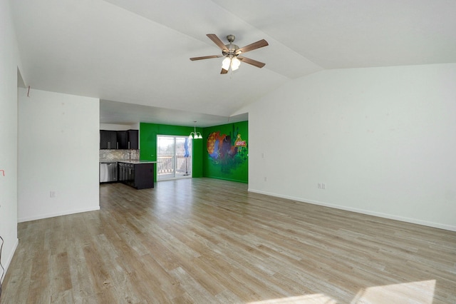 unfurnished living room with ceiling fan, vaulted ceiling, light wood-type flooring, and baseboards