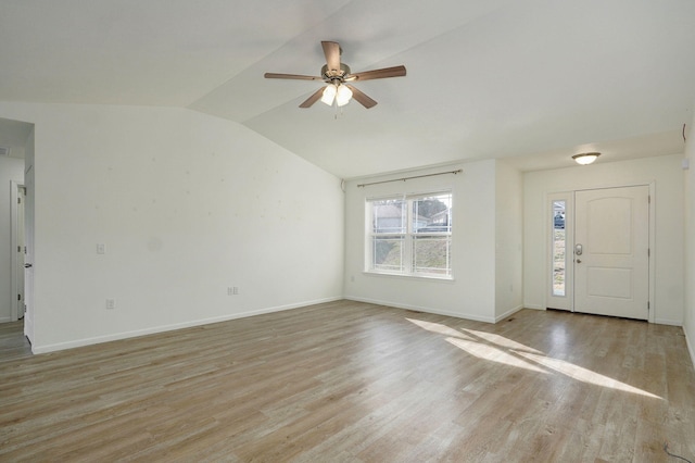 interior space with vaulted ceiling, light wood-style flooring, baseboards, and ceiling fan