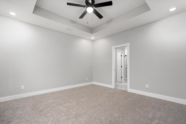 carpeted empty room featuring baseboards, a tray ceiling, a ceiling fan, and recessed lighting