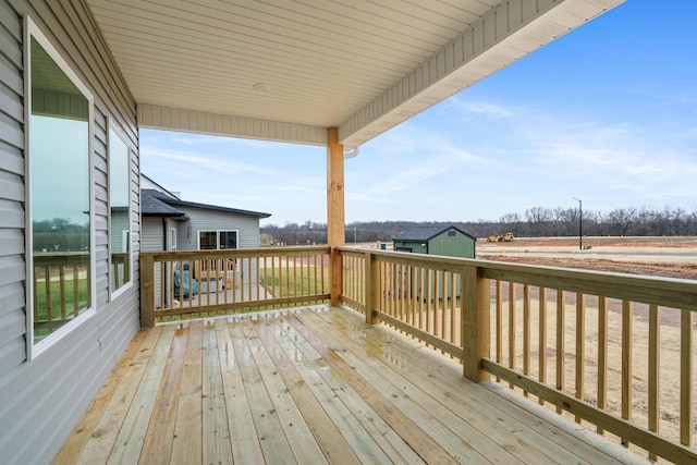 wooden deck featuring an outbuilding