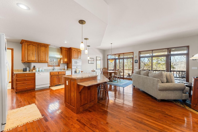 230 Temple Ln, Shell Knob, MO 65747 - kitchen with hardwood / wood-style flooring, white appliances, a sink, a center island, and brown cabinetry