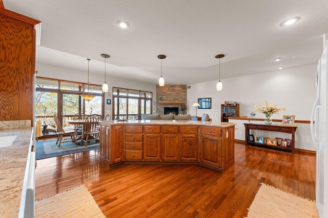 230 Temple Ln, Shell Knob, MO 65747 - kitchen featuring hanging light fixtures, a fireplace, light countertops, and dark wood-style flooring