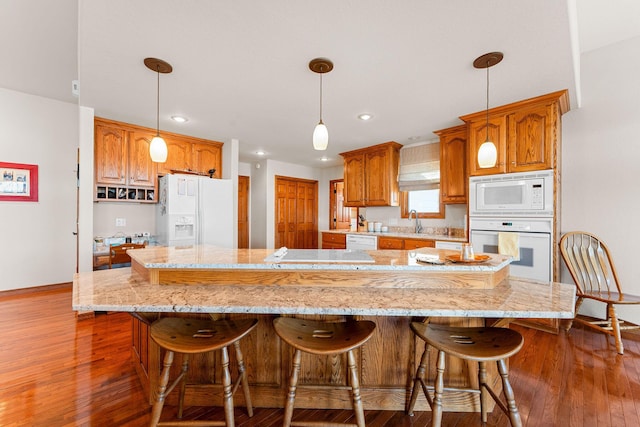 230 Temple Ln, Shell Knob, MO 65747 - kitchen featuring white appliances, wood-type flooring, a breakfast bar, and a sink