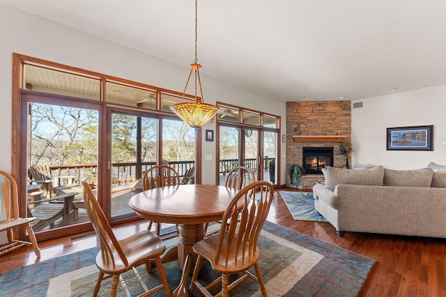 230 Temple Ln, Shell Knob, MO 65747 - dining area with visible vents, dark wood finished floors, and a stone fireplace