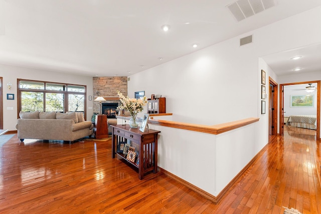 230 Temple Ln, Shell Knob, MO 65747 - interior space featuring visible vents, a stone fireplace, baseboards, and hardwood / wood-style flooring