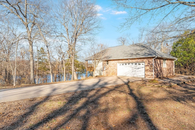 230 Temple Ln, Shell Knob, MO 65747 - view of side of property featuring brick siding, driveway, and an attached garage