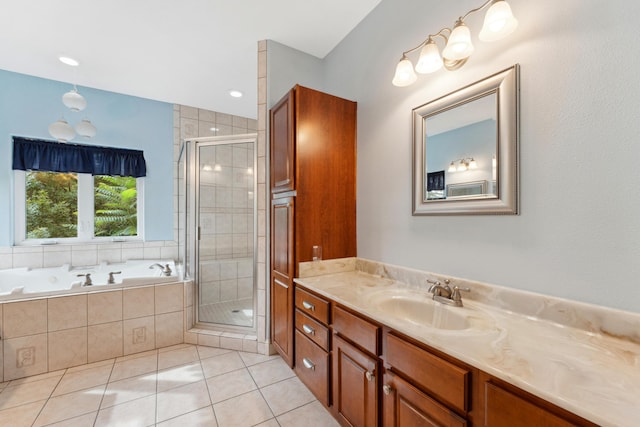 bathroom featuring a stall shower, vanity, a bath, and tile patterned floors