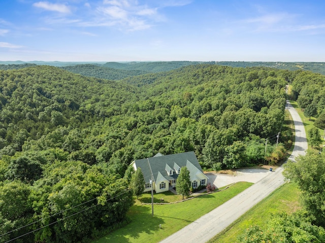 drone / aerial view featuring a view of trees