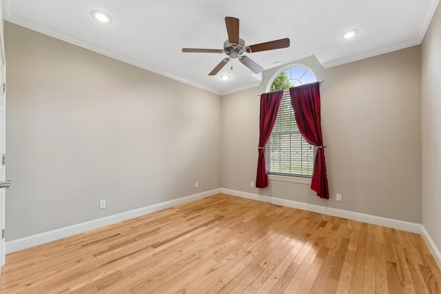 empty room featuring crown molding, light wood finished floors, recessed lighting, and baseboards