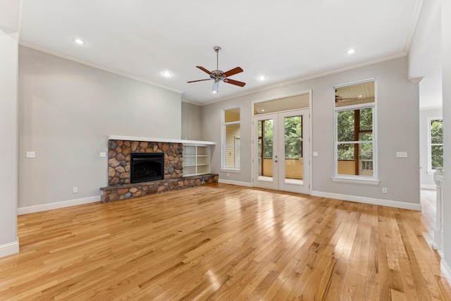 unfurnished living room featuring recessed lighting, a fireplace, baseboards, light wood finished floors, and crown molding