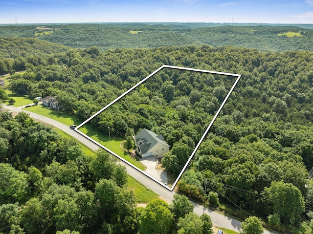 birds eye view of property featuring a forest view