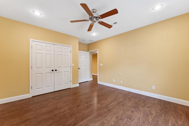 unfurnished bedroom with a closet, ceiling fan, baseboards, and wood finished floors